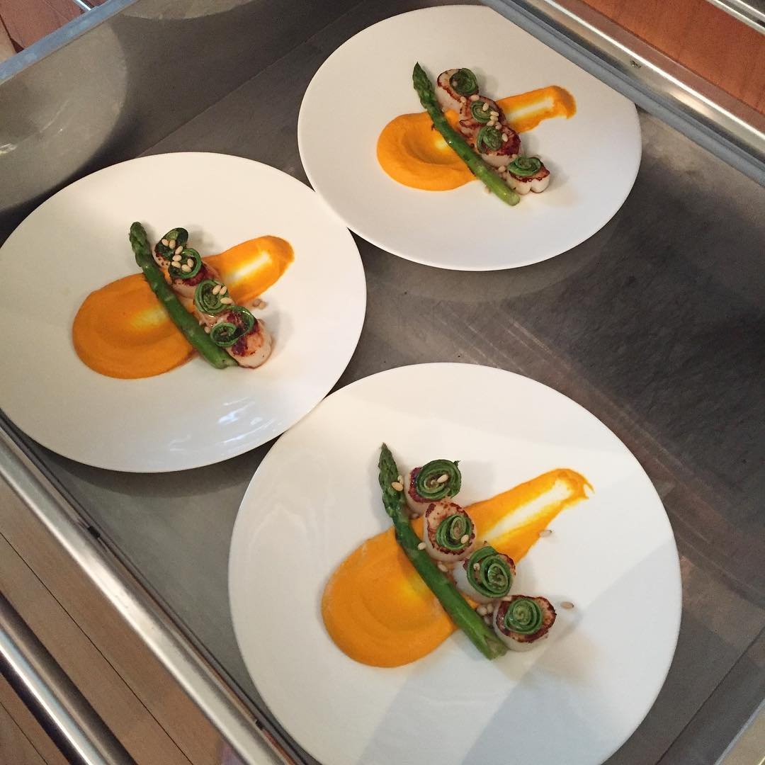 Scallops, asparagus, carrots, cassava, fiddle heads